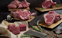 Variety of uncooked beef on cutting boards